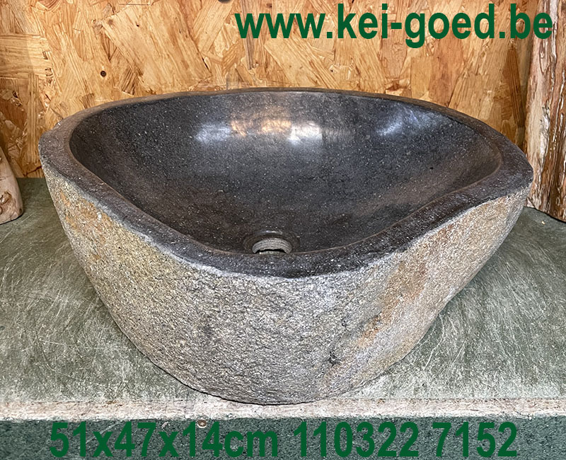 Washbasin of natural stone on industrial wood
