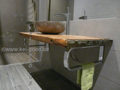 rivierstenen wastafel op oude houten plaat